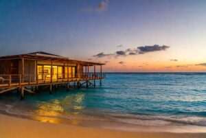 Beautiful overwater bungalow at sunset in Thailand, perfect for dream home aspirations.